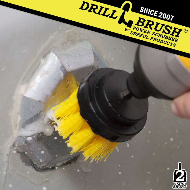 Drillbrush 2 inch Short Medium Yellow Bathroom Brush cleaning a tub overflow plate.