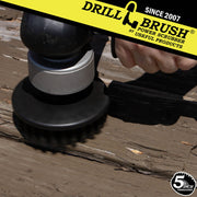 Drillbrush Ultra Stiff Black 5 inch Threaded brush removing paint from an old wooden table.