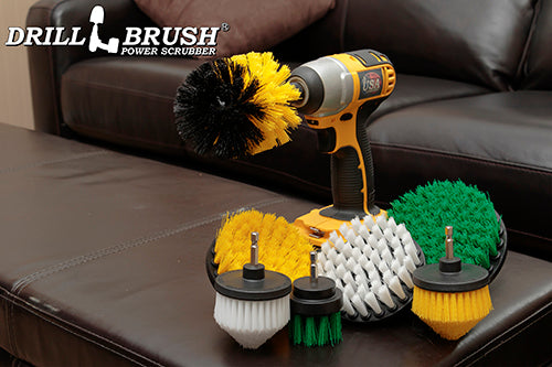 7-piece Drillbrush Variety kit featuring Soft White 4 inch and Cone-shaped brushes, Medium Yellow 4 inch, Cone-shaped, and Original brushes, and Medium Green 2 inch Short and 5 inch brushes on a living room coffee table.