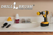 Drillbrush 2 inch Short Medium Yellow Bathroom Brush in a cordless drill on a bathroom counter in front of a sink and some toiletries.