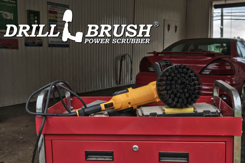 Ultra Stiff Black Grill & Industrial 7 inch Drillbrush in a variable speed polisher sitting on a tool box in front of a red sedan in a car wash.
