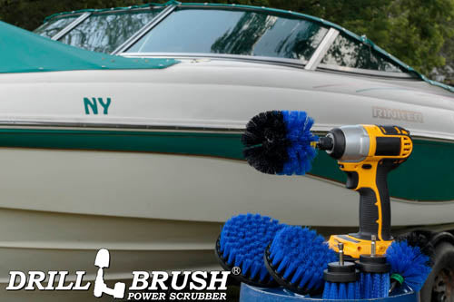 The Drillbrush 542OMS-2L Medium Blue Marine & Pool Brush Kit in a cordless drill sitting on a bucket in front of a boat on a trailer.