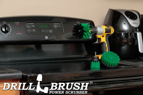 The Drillbrush 4OS-2L Medium Green Kitchen Brush Kit in a cordless drill sitting on a stovetop in front of a coffeemaker.