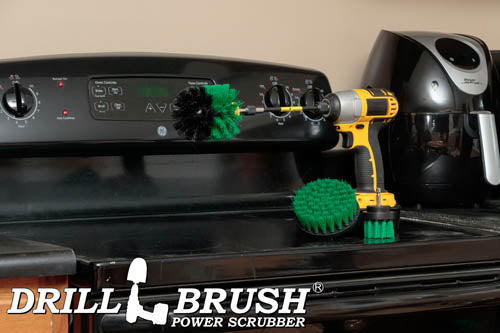 The Drillbrush 42O-5X Medium Green Kitchen Brush Kit in a cordless drill sitting on a stovetop in front of a coffee maker.