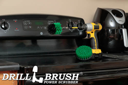 The Drillbrush 4M-5X Medium Green Kitchen Brush Kit in a cordless drill sitting on a stovetop in front of a coffeemaker.