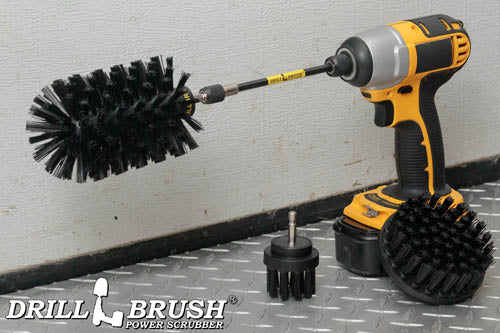 The Drillbrush 42J-5X Ultra Stiff Black Grill & Industrial Brush Kit in a cordless drill sitting on diamond plate flooring in a garage.