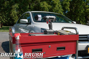Drillbrush Mini Soft White Home & Auto Brush in a cordless drill on a tool cart in front of a white sedan.