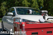 The Drillbrush 4M-5X Medium Green Kitchen Brush Kit in a cordless drill sitting on a tool cart in front of a white sedan.