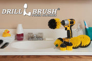 The Drillbrush 542OMS-2L Medium Yellow Bathroom Brush Kit in a cordless drill sitting on a bathroom counter next to a sink and toiletries.
