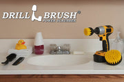 The Drillbrush 42 Medium Yellow Bathroom Brush Kit in a cordless drill sitting on a bathroom counter next to a sink and toiletries.