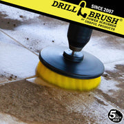 Drillbrush 5 inch Hex Medium Yellow Bathroom Brush cleaning a dirt-covered tile floor.