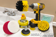 Drillbrush Medium Yellow 4 inch, 2 inch Short, and Original brushes with a Soft White and Stiff Red 4 inch scrub pad, a 3 inch pad backer, and All-Purpose Useful Cleaning Paste in front of a drill that is holding the Original brush. The kit and drill are resting on a bathroom sink counter near a rubber duck.