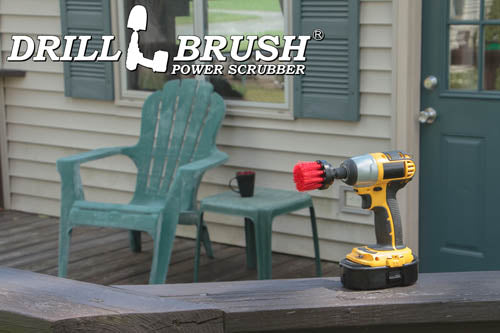 Drillbrush 2 inch Long Stiff Red Outdoor & Patio Brush on a deck railing in front of some vinyl furniture on a deck.