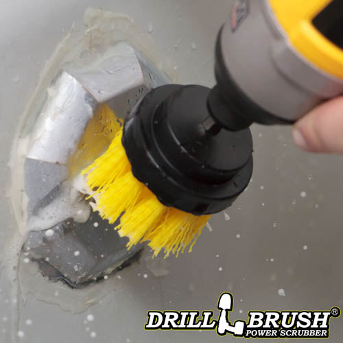 Drillbrush 2 inch Short Medium Yellow Bathroom Brush cleaning a tub overflow plate.
