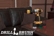 The Drillbrush Soft White, Medium Yellow, Medium Green, and Stiff Red 2 inch Short 4-piece Variety Brush Kit on a wooden desk in front of a leather sofa.