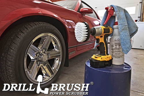 Drillbrush 4 inch Soft White Home & Auto Brush in a cordless drill on a bucket next to a spray bottle and shop rag in front of the rims of a red sports car.