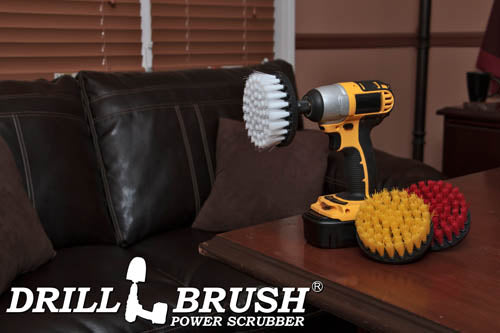 The Drillbrush Soft White, Medium Yellow, and Stiff Red 4 inch 3-piece Variety Brush Kit sitting on a desk in front of a leather sofa.