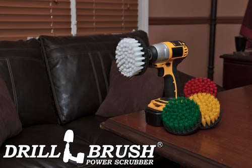 The Drillbrush 4-piece 4 inch Flat Brush kit on a desk in an office in front of a sofa.