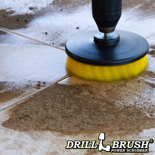 Drillbrush 5 inch Hex Medium Yellow Bathroom Brush cleaning a dirt-covered tile floor.