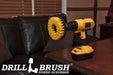 Drillbrush 5 inch Hex Medium Yellow Bathroom Brush in a cordless drill on a wooden desk in front of a leather sofa.