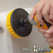 Drillbrush 5 inch Medium Yellow Bathroom Brush cleaning the walls of a shower.
