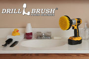 Drillbrush 5 inch Medium Yellow Bathroom Brush in a cordless drill on a bathroom counter in front of a sink and some toiletries.