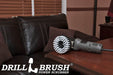 Drillbrush 5 inch Threaded Soft White Home & Auto Brush in a variable speed polisher on a wooden desk in front of a leather sofa.