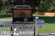 The Drillbrush Aggressive Black 6 inch Scrubbing Pad on an open grill on a deck in front of a backyard.