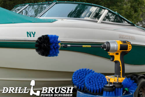 The Drillbrush 542OMS-2L-7X Medium Blue Marine & Pool Brush Kit in a cordless drill sitting on a bucket in front of a boat on a trailer.