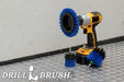 The Drillbrush EMS-2L Medium Blue Marine & Pool Brush Kit in a cordless drill sitting on a diamond plate floor in a garage.