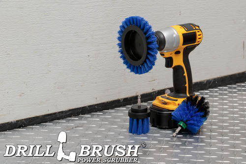 The Drillbrush EMS-2L Medium Blue Marine & Pool Brush Kit in a cordless drill sitting on a diamond plate floor in a garage.