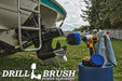 The Drillbrush 4O Medium Blue Marine & Pool Brush Kit in a cordless drill sitting on a bucket next to a spray bottle and rag in front of a boat on a trailer.