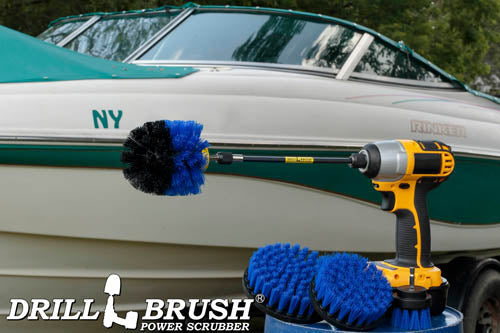 The Drillbrush 542O-7X Medium Blue Marine & Pool Brush Kit in a cordless drill sitting on a bucket in front of a boat on a trailer.