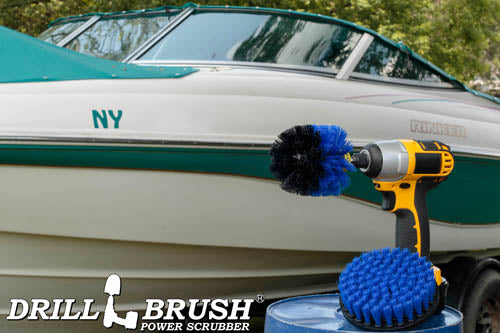 The Drillbrush 5O Medium Blue Marine & Pool Brush Kit in a cordless drill sitting on a bucket in front of a boat on a trailer.
