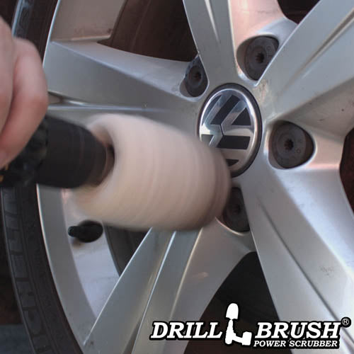 A Drillbrush Cotton Buffer cleaning rims on a car.