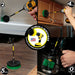 Action shots of a Medium Green Original brush in a 7 inch extension cleaning a coffee pot, a Medium Green 2 inch Short Drillbrush in a 7 inch cleaning a refrigerator shelf, a Medium Green 4 inch Drillbrush in a 7 inch extension cleaning a cabinet, and a Medium Green 5 inch Drillbrush in a 7 inch extension cleaning a kitchen floor.