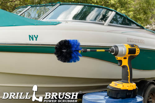 Drillbrush Original Medium Blue Marine & Pool Brush in a 5 inch extension in a cordless drill on a bucket in front of a boat on a trailer in a backyard.