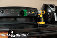 Drillbrush Original Medium Green Kitchen Brush in a 5 inch extension on a stovetop in front of an air fryer.