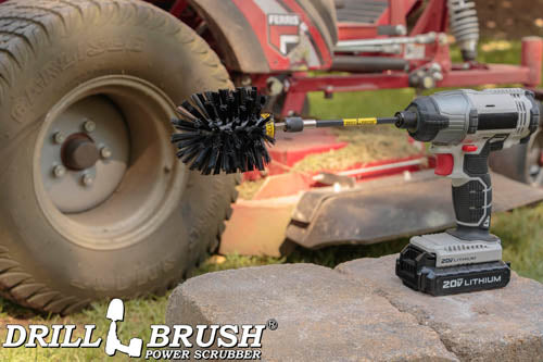 Drillbrush Original Ultra Stiff Black Grill & Industrial Brush in a 5 inch extension on stone bricks in front of a lawnmower.