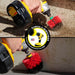 Action shots of a Stiff Red Original brush and a Stiff Red Mini cleaning cut grass.
