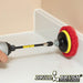 The Drillbrush Moderate Red 4 inch Scrubbing Pads on a 3 inch backer attached to an extension in a cordless drill cleaning the backsplash on a bathroom counter.