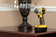 The Drillbrush Threaded 5/8in-11 threads-per-inch bolt to 1/4in Quickchange Adpater in a cordless drill on a wooden end table in front of a lamp.