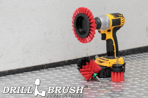 The Drillbrush EMS-2L Red Stiff Outdoor & Patio Brush Kit in a cordless drill sitting on a diamond plating floor in a garage.