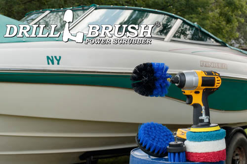 The Medium Blue Drillbrush 42O Marine & Pool Kit with three 4 inch Variety Pads with an Original in a cordless drill on a bucket in front of a boat on a trailer.