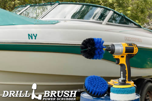 The Medium Blue Drillbrush 4O Marine & Pool Kit with two 4 inch Variety Pads with an Original in a cordless drill on a bucket in front of a boat on a trailer.
