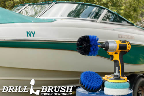 The Medium Blue Drillbrush 4O Marine & Pool Kit with two 4 inch Variety Pads with an Original in a cordless drill on a bucket in front of a boat on a trailer.
