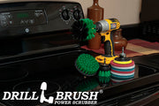 The Medium Green Drillbrush 42O Kitchen Kit with six Variety Pads with an Original in a cordless drill on a stovetop in front of a coffee maker.