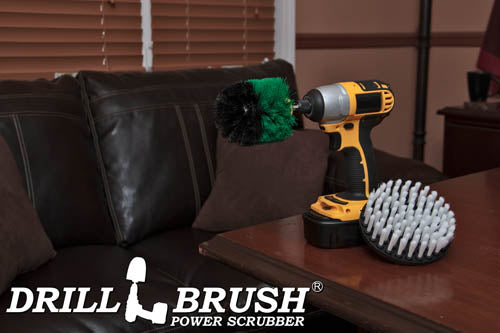 The Drillbrush Medium Green Original and Soft White 5 inch Variety Brush Kit on a wooden desk in front of a leather sofa.
