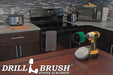 The Drillbrush Medium Green Original and Soft White 5 inch Variety Brush Kit on a table in front of kitchen counters, a stove, a microwave, and other appliances.