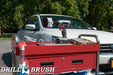 Drillbrush Original Soft White Home & Auto Brush in a cordless drill on a tool cart in front of a white sedan.